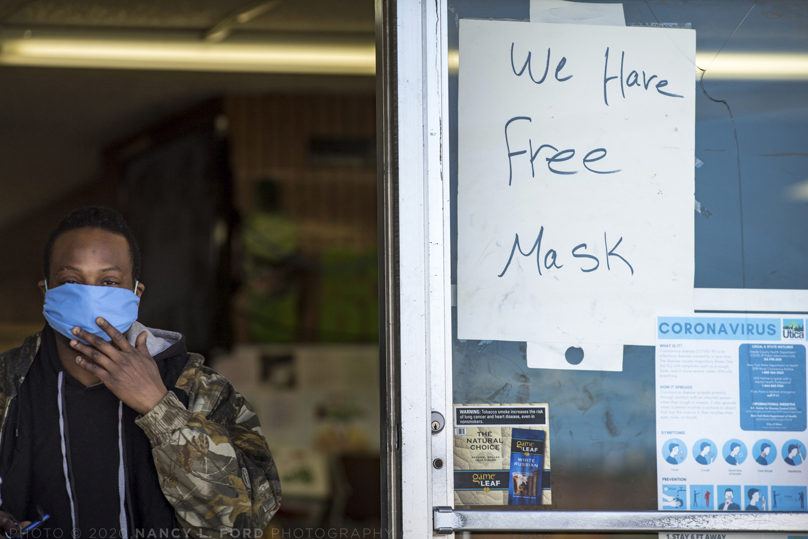 A man leaves the Eagle St. Express Market where they are giving away free masks on Saturday, April 25, 2020 in Utica, NY during the Covid-19 pandemic lockdown in New York State.  (Copyright © 2020 Nancy L. Ford Photography)